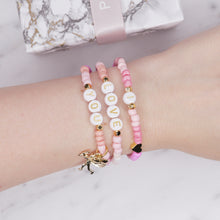 Load image into Gallery viewer, 24k gold plated painted bead elastic stretchy bracelets multicolour pink shades &#39;i love you&#39; cupid charm heart plastic gold heart rondelle 3 bracelets on wrist
