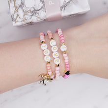 Load image into Gallery viewer, 24k gold plated painted bead elastic stretchy bracelets multicolour pink shades 'i love you' cupid charm heart plastic gold heart rondelle 3 bracelets on wrist