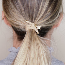 Load image into Gallery viewer, charm hair bands hair ties various colours gold star crystals with tag on jewellery tan beige on marble on blonde girl balayage ombre hair