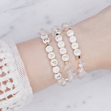 Load image into Gallery viewer, 24k gold plated clear crystal quartz natural precious stone healing stone gold plated bracelet pearl shimmer gold letter beads word on marble on wrist lacy top
