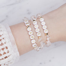 Load image into Gallery viewer, 24k gold plated clear crystal quartz natural precious stone healing stone gold plated bracelet pearl shimmer gold letter beads word on marble on wrist lacy top