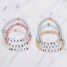 Load image into Gallery viewer, 24k gold plated elastic stretch bracelets names ethan phoebe molly esme rory grace evil eye enamel pink star 6 bracelets grey silver blue pink shimmer pearl sugar cookie biscuit blue grey on marble custom word personalised letters
