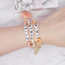 Load image into Gallery viewer, 24k gold plated painted bead elastic bracelets orange coral white shimmer pink enamel gold bee white cream tassel black heart accent feature bead plastic letter beads word personalised custom on wrist