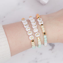 Load image into Gallery viewer, my little sister multicolour pastel stretch elastic bracelets orange pink champagne green mint white 24k gold plated star rondelle shimmer gold letter plastic beads on wrist
