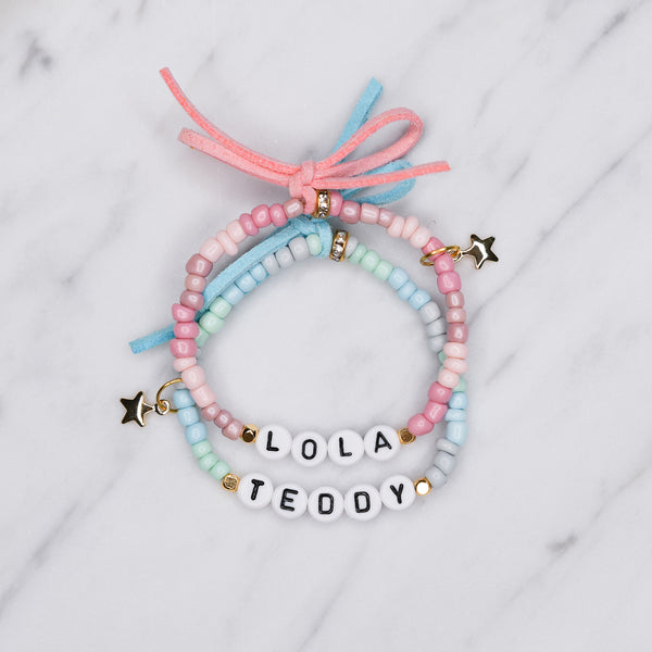 ombre pink blue painted beaded stretch elastic bracelets suede bows colourful gradient pattern gold plated star charms lola teddy girls boys childrens name custom personalised rondelle sparkly plastic beads on marble