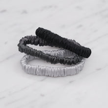 Load image into Gallery viewer, black dark grey monochrome ink grey cool silver trio three set mulberry silk soft hair tie hair band stretchy and kind to your hair on marble