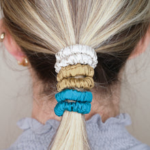Load image into Gallery viewer, forest mud yellow mustard green turquoise grey warm silver trio three set mulberry silk soft hair tie hair band stretchy and kind to your hair on blonde girl balayage ombre hair