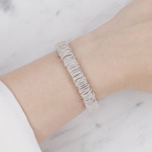 Load image into Gallery viewer, silver warm grey mulberry silk soft hair tie hair band stretchy and kind to your hair on wrist