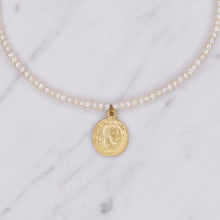 Load image into Gallery viewer, button pearls and matte gold plated greek pendant head double sided coin necklace close up on marble