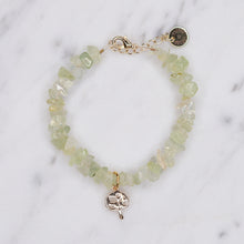 Load image into Gallery viewer, Prehnite green precious stone chain bracelet healing properties tree of life charm gold plated charm lobster clasp on marble
