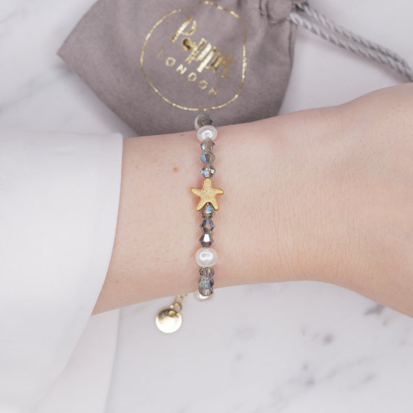 Smokey Crystal bicone Freshwater Pearl And 24K Gold Plated matte gold Starfish Bracelet on wrist