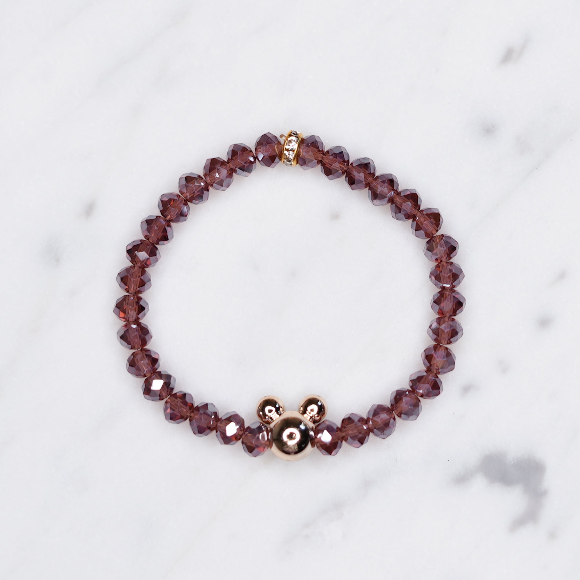 Mauve Crystal Rondelle Bead Bracelet With Gold Mickey Mouse Bead