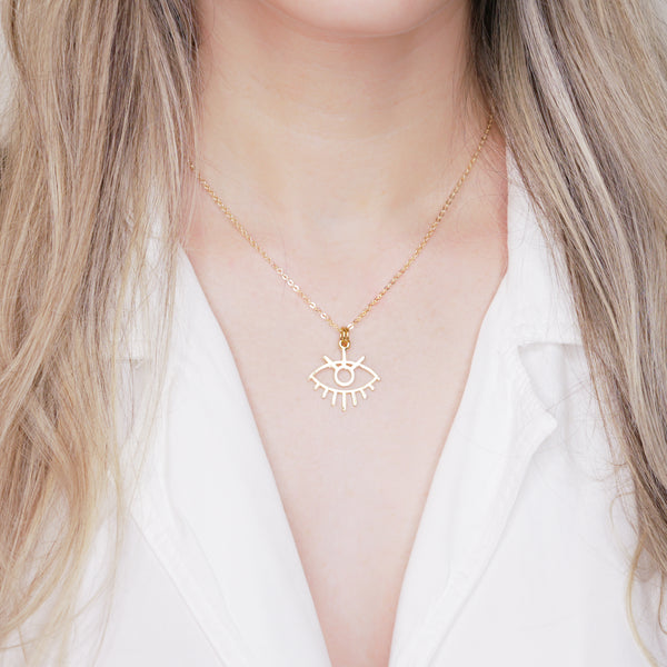 24k gold plated evil eye statement chain charm pendant necklace on blonde woman neck neckline