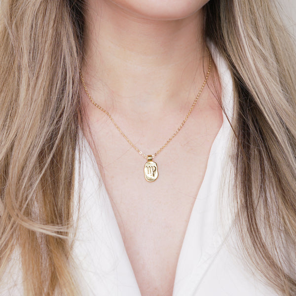 24k gold plated zodiac sign virgo star sign starsign pendant engraved embossed chain necklace on marble on blonde girls neck