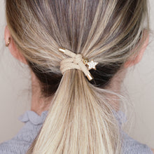 Load image into Gallery viewer, charm hair bands hair ties various colours gold star crystals with tag on jewellery tan beige on marble on blonde girl balayage ombre hair
