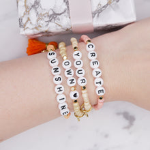 Load image into Gallery viewer, create your own sunshine pink coral orange champagne shimmer painted beaded bracelets gold plated stars charms sunflower orange tassel affirmation bracelets stack colourful on wrist
