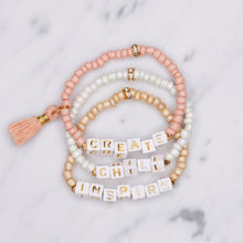 Load image into Gallery viewer, 24k gold plated beaded cubic building block letter initial beads charm tassel painted pink beige biscuit white shimmer elastic stretchy gold bracelets create chill inspire affirmation
