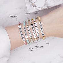 Load image into Gallery viewer, 24k gold plated elastic stretch bracelets names ethan phoebe molly esme rory grace evil eye enamel pink star 6 bracelets grey silver blue pink shimmer pearl sugar cookie biscuit blue grey on marble custom word personalised letters on wrist
