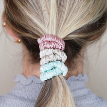 Load image into Gallery viewer, candy pink light baby blue grey warm silver trio three set mulberry silk soft hair tie hair band stretchy and kind to your hair on blond girl ombre balayage hair
