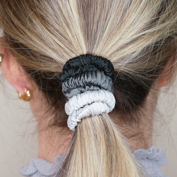 black dark grey monochrome ink grey cool silver trio three set mulberry silk soft hair tie hair band stretchy and kind to your hair on blonde girl balayage ombre hair