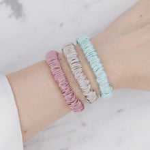 Load image into Gallery viewer, candy pink light baby blue grey warm silver trio three  set mulberry silk soft hair tie hair band stretchy and kind to your hair on wrist
