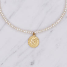Load image into Gallery viewer, button pearls and matte gold plated greek pendant head double sided coin necklace close up on marble
