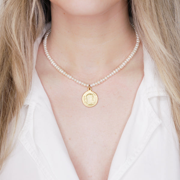 button pearls and matte gold plated greek pendant head double sided coin necklace wire lobster clasp on blonde girl neck
