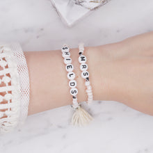 Load image into Gallery viewer, sparkling white shimmer painted bead pearlised bracelets mrs wife wedding style cream tassel and puffy heart charms sparkling rondelle silver beads acrylic black letter beads on wrist
