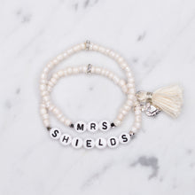 Load image into Gallery viewer, sparkling white shimmer painted bead pearlised bracelets mrs wife wedding style cream tassel and puffy heart charms sparkling rondelle silver beads acrylic black letter beads on marble
