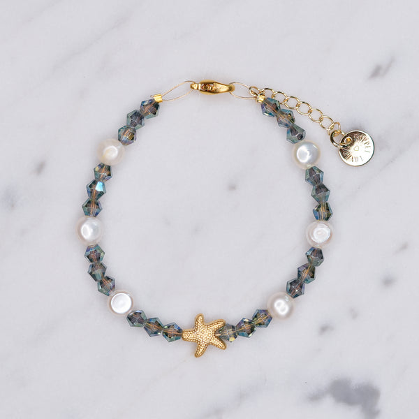 Smokey Crystal bicone Freshwater Pearl And 24K Gold Plated matte gold Starfish Bracelet on marble