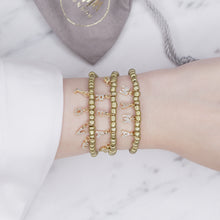 Load image into Gallery viewer, antique gold painted beaded elastic stretchy bracelet 24k gold plated micro pave zirconia letter initial charm words personalised rondelle bead on marble on wrist
