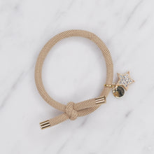 Load image into Gallery viewer, charm hair bands hair ties various colours gold star crystals with tag on jewellery tan beige on marble
