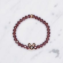 Load image into Gallery viewer, mauve dark ab shimmer rondelle crystal beads elastic stretch bracelet with mickey mouse plastic gold bead on marble
