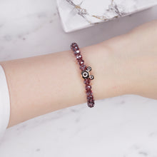 Load image into Gallery viewer, mauve dark ab shimmer rondelle crystal beads elastic stretch bracelet with mickey mouse plastic gold bead on wrist
