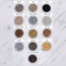 Load image into Gallery viewer, colour choice for painted stretch beaded bracelets labelled black greys metallic gold silver dark antique bronze gunmetal rose gold antique gold antique bronze silver drop smoke shimmer dorian grey fawn heather on marble
