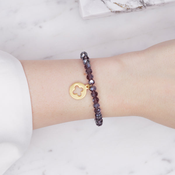 plum purple dark ab shimmer rondelle crystal beads elastic stretch bracelet with clover cross 24K matte gold charm on wrist